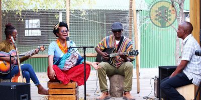 Musicians performing at a Poetavango acoustic session