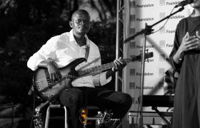 Poetavango performer on stage with band members