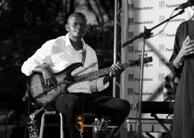 Poetavango performer on stage with band members