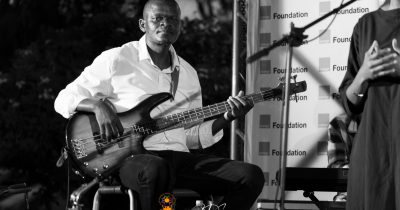 Poetavango performer on stage with band members