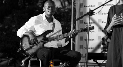 Poetavango performer on stage with band members