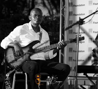 Poetavango performer on stage with band members