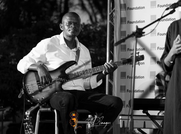 Poetavango performer on stage with band members